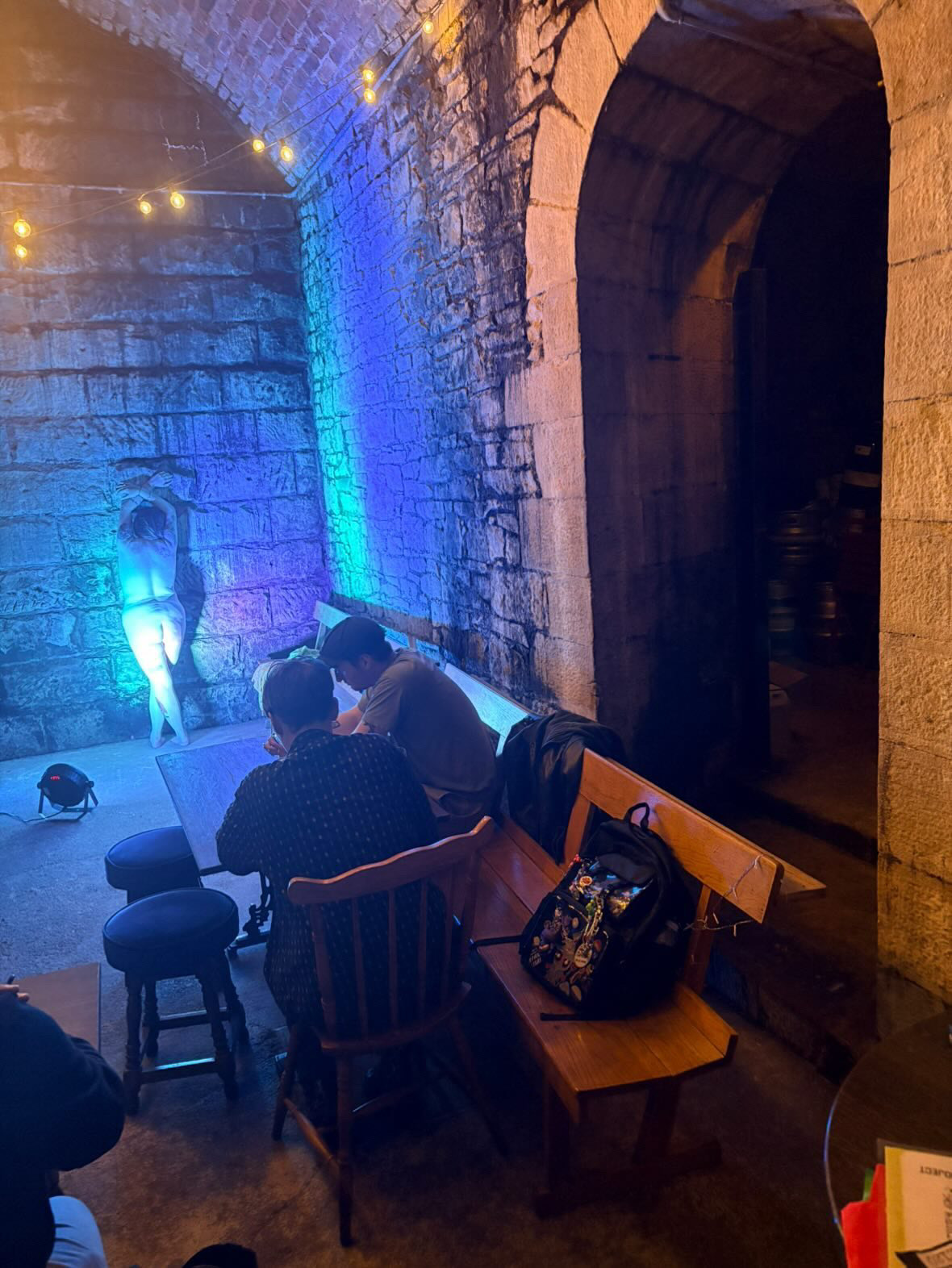 A moody, blue-lit life drawing session