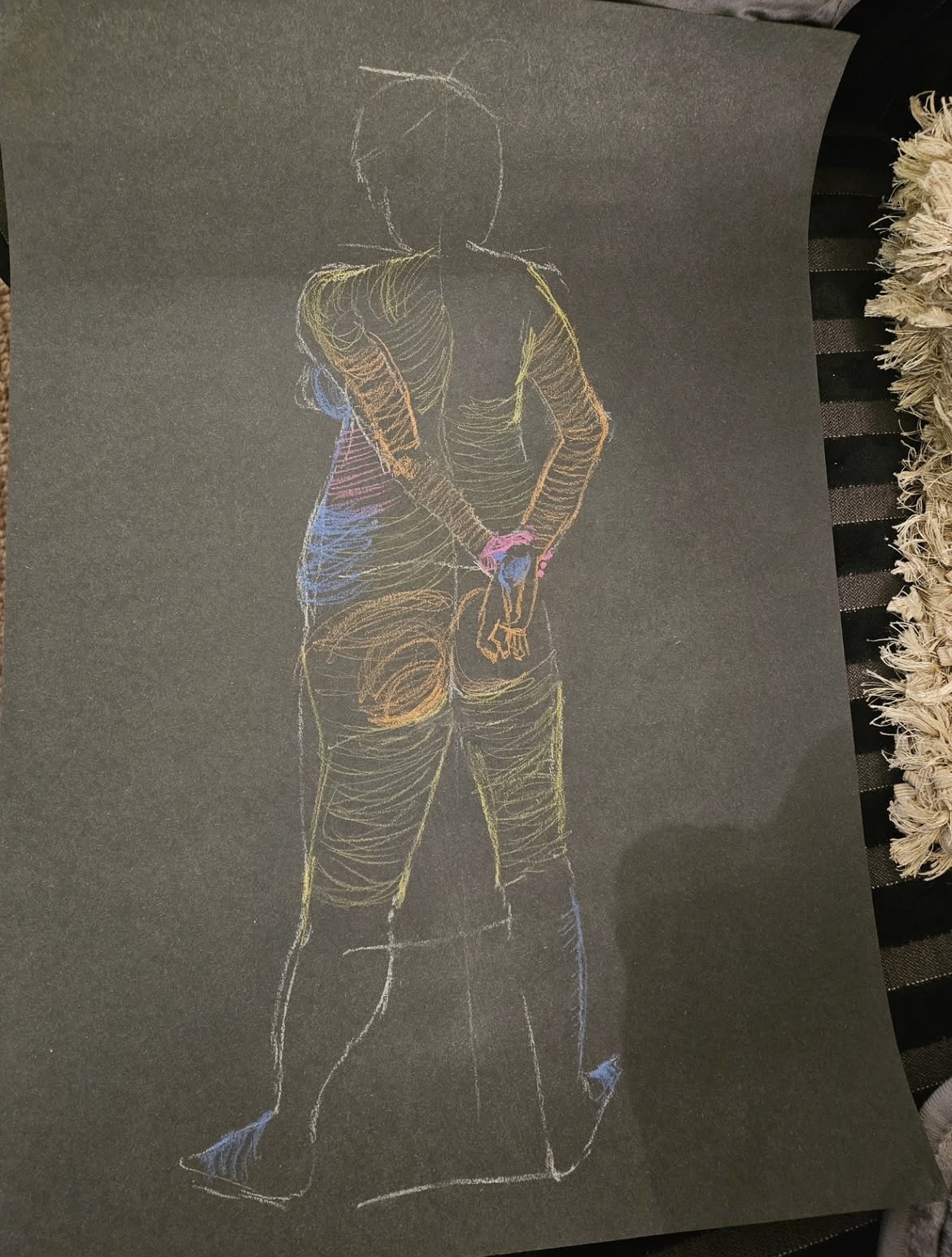 A gold-lit figure drawing